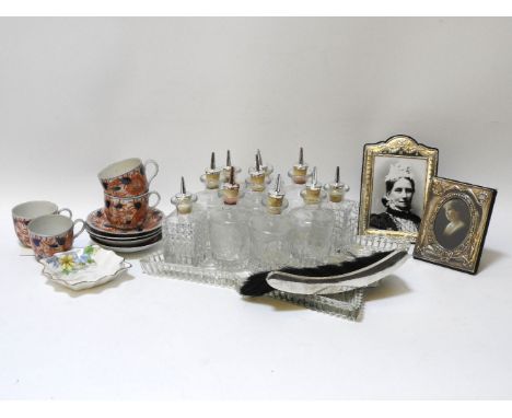 Two silver and velvet backed photograph frames together with four Imari decorated tea cups and saucers dressing table bottles