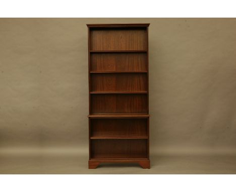 A floor standing mahogany open bookcase, with adjustable shelves above further shelves, on bracket feet, 92cm wide, 28cm deep