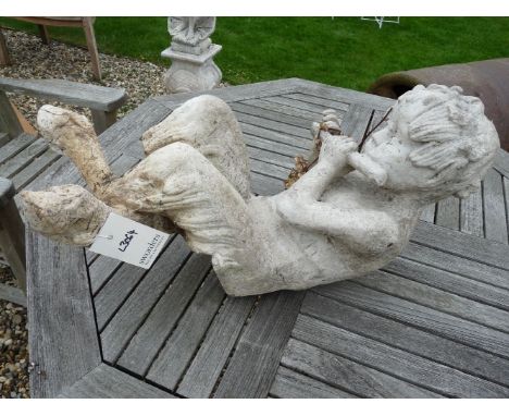 A composition seated faun, playing the pan pipes, 65cm high