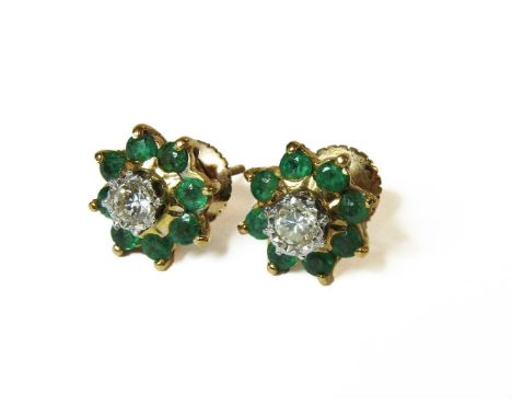 A pair of gold illusion set diamond and emerald cluster earrings, (tested as approximately 18ct gold with later lower carat s