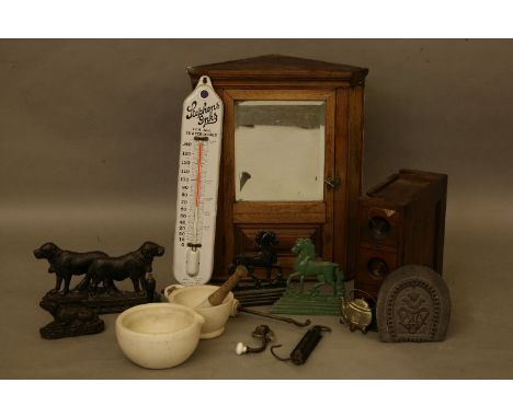 A small oak corner cabinet, mahogany nest of drawers, a kitchen thermometer, a collection of doorstops and related wares