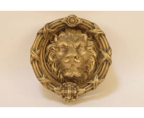 A large brass door knocker, with lions mask with cast ring handle, 23cm diameter