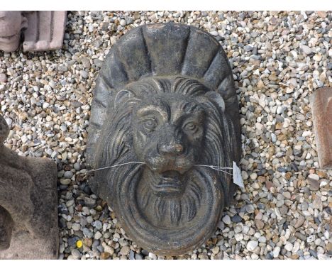 A cast metal and painted lion mask bracket, the lion holding a ring in its mouth, approximately 60cm high