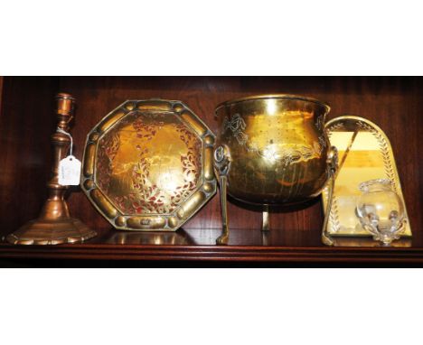 A brass wall sconce, of octagonal form, pierced with a couple, lacking a candle branch, backed with red cloth, a candlestick,