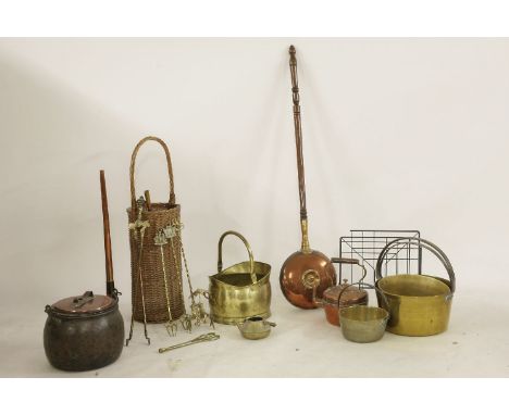 A collection of brass jam pans, a wicker basket, fire irons, a copper lidded saucepan, kettle, 1950's magazine rack, and a hu