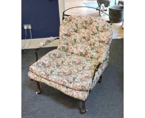 A Victorian strap iron and brass campaign bed/chair, on ceramic casters. 85cm wide