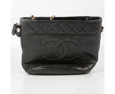 Chanel - a lady's 1960's vintage black leather handbag, stitched double C emblem, 45mm wide diamond shape stitched quilted pa