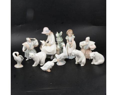 Three Lladro models of polar bears, other Nao and similar Spanish porcelain figurines.