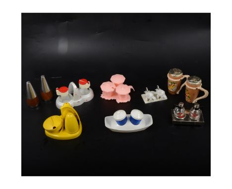 A vintage ceramic salt and pepper set, black and white stripes, on boat-shaped stand; another with yellow and white stripes; 