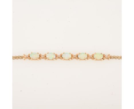 An opal and diamond bracelet, five oval cabochon cut opals 7mm x 5mm, individually claw set and space by six small diamonds, 
