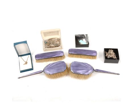 A four-piece purple enamel and silver backed dressing table set, maker's mark rubbed, Birmingham 1935, comprising four brushe