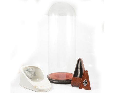 Glass dome, diameter 25cm, height 67cm, on a stand, slipper shape chamber pot, and metronome.