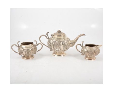 Indian silver-plated three piece teaset, decorated with palm trees and fish, elephant finial to teapot, serpent handles.