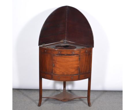 George III mahogany cylinder front corner washstand, with a flap-over top enclosing a basin recess, door and drawer under, on