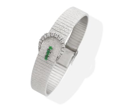 EMERALD AND DIAMOND-SET BRACELET, CIRCA 1969Brilliant-cut diamonds and step-cut emeralds, on an 18 carat white gold textured 