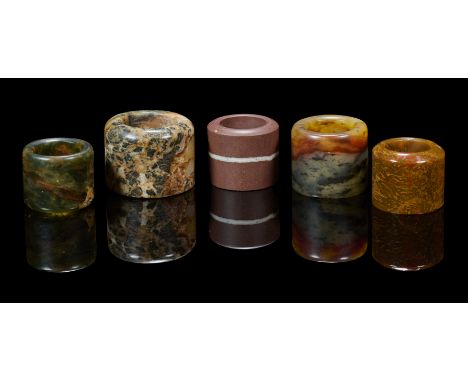 comprising: a large pudding stone ring, 2.7cm high; a reddish-brown pudding stone ring, 2.5cm high; a grey and orange pudding
