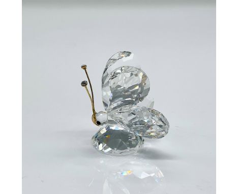 This retired butterfly is made from clear faceted crystal and has gold antennae with a large gold nose that covers most of th