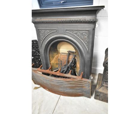 A Victorian style cast iron fire surround, together with a Swans nest style fire grate and dogs