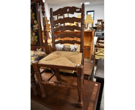 A traditional ladder back kitchen chair having rush seat