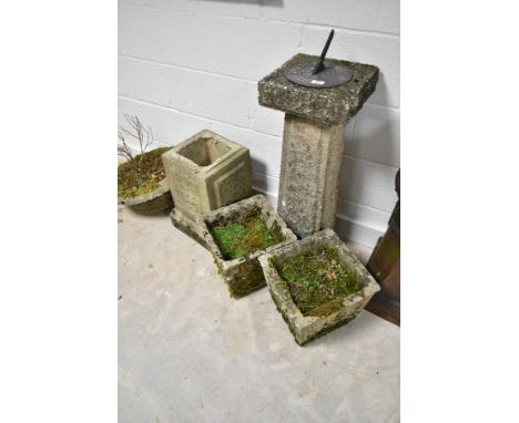 A selection of concrete garden planters and sundial