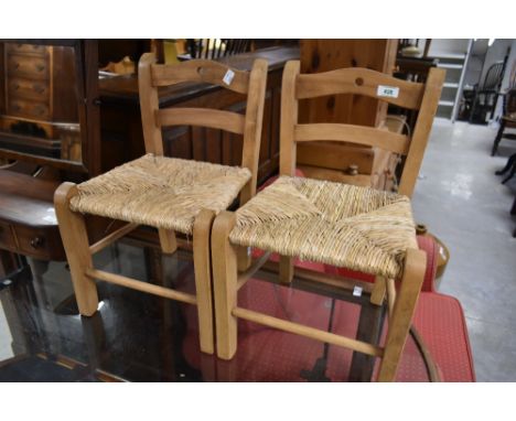 A pair of vintage rush seated child's chairs
