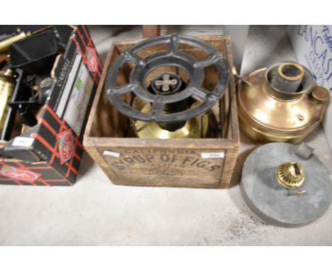 A vintage Primus stove, sold with small fig crate and two oil lamps