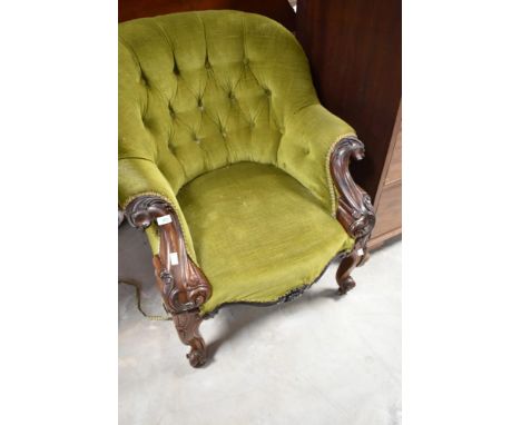 A Victorian button back armchair having knurl frame