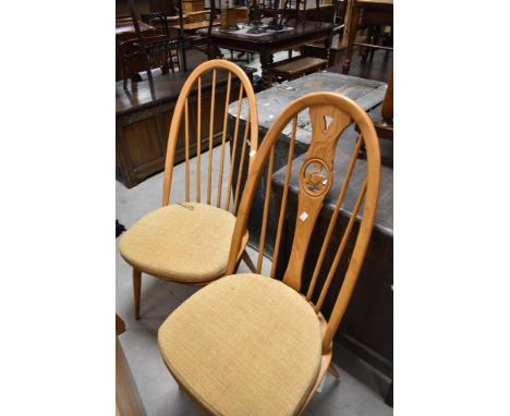 Two pairs of Ercol high back dining chairs, one pair having hoop and stick back, the other having swan motif