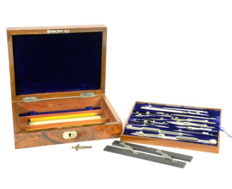 A SET OF NICKEL BRASS DRAUGHTSMENS' INSTRUMENTS INCLUDING AN EBONY PARALLEL RULE AND A BOXWOOD RULE BY THE ARMY & NAVY CSL IN