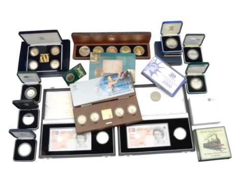 A collection of silver proof commemorative and other coins comprising United Kingdom Elizabeth II: 2002 Crown and £10 Banknot