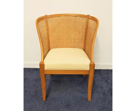 WILLIS & GAMBIER LIGHT OAK BEDROOM CHAIRwith a shaped high caned back above a padded seat, standing on shaped tapering suppor