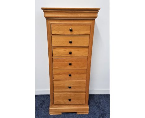 WILLIS & GAMBIER LIGHT OAK CHEST OF DRAWERSof narrow proportions with a moulded top above a cushion frieze drawer and seven s