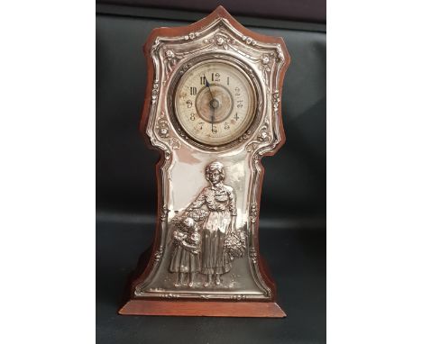 GEORGE V SILVER PHOTOGRAPH FRAMEBirmingham 1927, 16cm high, together with a silver mounted mantle clock in the form of a mini