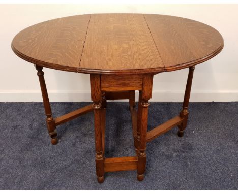 OAK GATE LEG TABLEwith shaped drop flaps, standing on turned supports, 77cm wide 