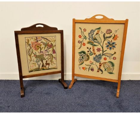 LIGHT OAK FIRE SCREENwith an embroided floral panel under glass, standing on shaped supports, 85cm high, together with a dark