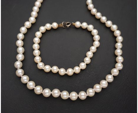 CULTURED PEARL NECKLACEthe pearls individually knotted, with nine carat gold clasp, 59cm long; together with a pearl bracelet