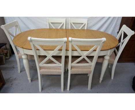LIGHT OAK AND PAINTED EXTENDING TABLEwith pull apart D ends and an extra leaf above a deep frieze, standing on turned taperin