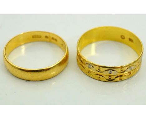 TWO GOLD WEDDING BANDSone in eighteen carat gold with engraved decoration, ring size M-N, the other in unmarked high carat go