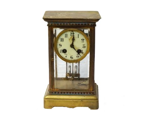 EDWARDIAN BRASS AND FOUR GLASS PANEL MANTLE CLOCKthe circular enamel dial with Arabic numerals and an eight day movement, wit