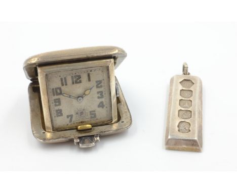 Art Deco silver cased travel clock by SSM Birmingham 1932 4cm square and 1977 Silver Jubilee ingot pendant   Condition Report