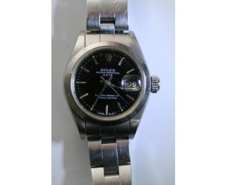 A ladies Rolex oyster perpetual chronometer wristwatch with magnified date aperture set on black face with stainless steel ba