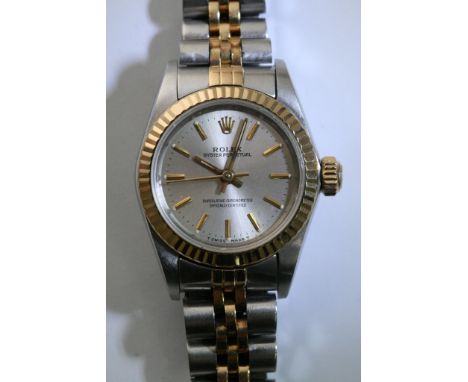 A ladies bi-metal Rolex Oyster Perpetual chronometer wristwatch with gold tone baton numerals set on a gold tone face with a 