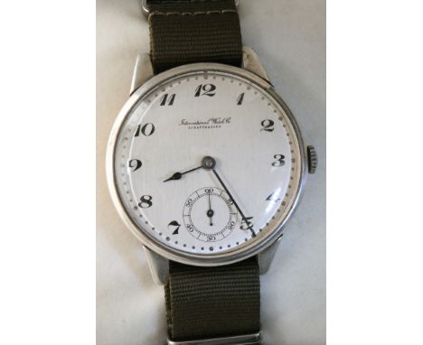 A box containing a large IWC watch with subsidiary dial, set on a material strap