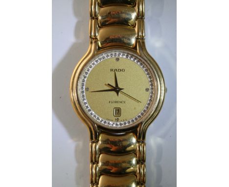 A ladies gold tone Rado 'Florence' wristwatch, the circumference of the face encrusted with white stones, each quarter is als