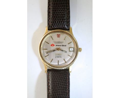 A gents Omega Constellation chronometer with tuning set to f300Hz, with gold tone casing set on a brown leather strap, with d