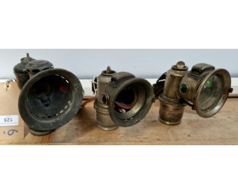 Three vintage Lucas carbide bicycle lamps; a Lucas 'Aceta' (no glass) lamp and two Lucas 'Calcia Cadet' lamps, both with no g