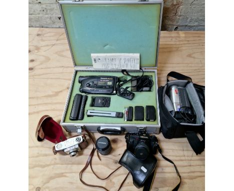 A vintage Panasonic R33 video camera with accessories in aluminium hard case together with a Canon V65Hi video camera in carr