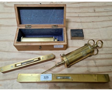 A collection of various old tools including two wood and brass spirit levels, a 19th century brass syringe possibly for medic