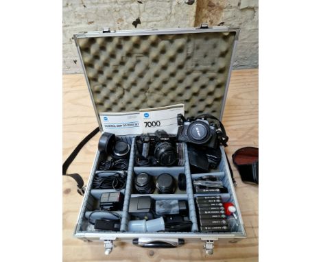 A Nikon camera and a Minolta camera with case and various accessories including lenses etc. 