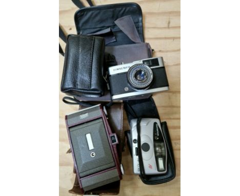 A 1950s - 1960 vintage folding Ross Ensign Selfix Snapper camera in case, a Olympus Trip 35 camera and a Olympus AF-10 XB.